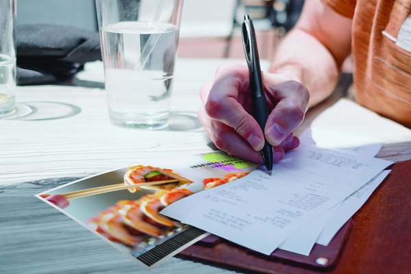image of a customer signing a check at a restaurant